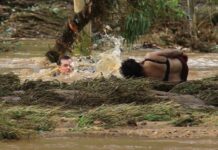 Hero cop almost swept away in brave rescue attempt